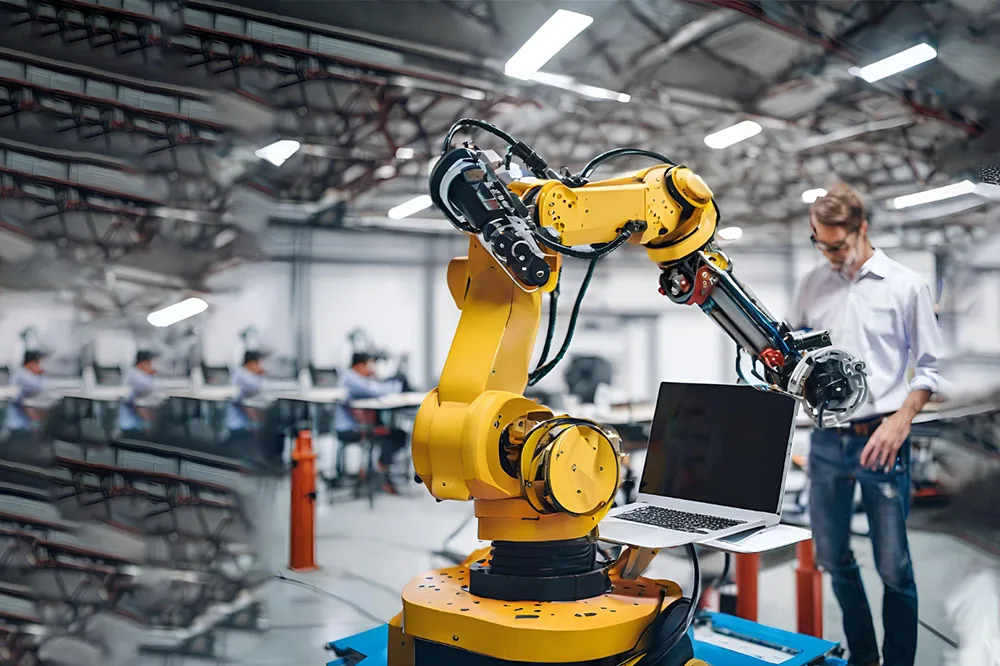 Industrial robot arm being programmed alongside a laptop in a training environment